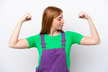 Young redhead woman isolated on white background doing strong gesture