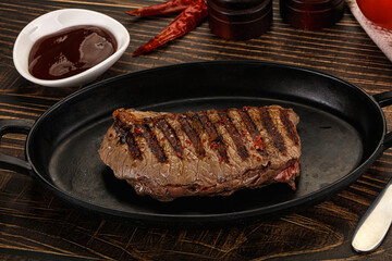 Grilled beef striploin steak with sauce