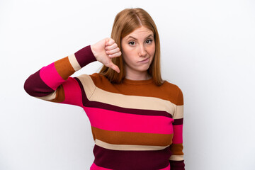 Young redhead woman isolated on white background showing thumb down with negative expression