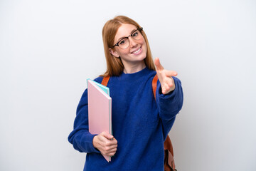 Young student redhead woman isolated on white background shaking hands for closing a good deal