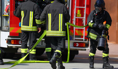 fire brigade in uniform during an emergency and fire truck
