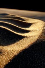 Obraz premium Close-up of textured desert sand, light-dappled