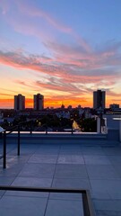 Obraz premium Stunning Rooftop View at Sunset with Colorful Skies and Urban Skyline