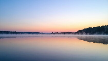 Fototapeta premium Serene Sunrise Over Misty Lake with Soft Pastel Colors and Reflection