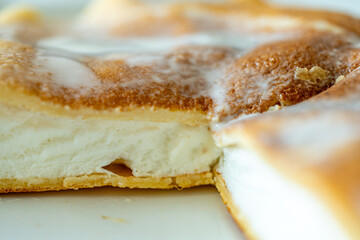 Slice of omelette poulard with pancakes on a light background. close-up