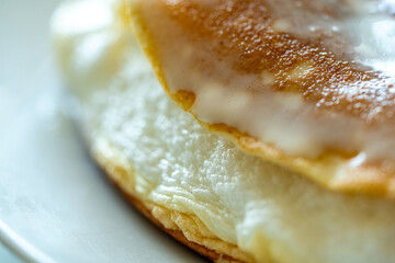 Slice of omelette poulard with pancakes on a light background. close-up