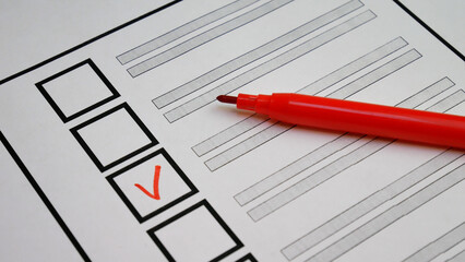 Person selects candidate with red marker on ballot. Italy elections. Transparent voting process...