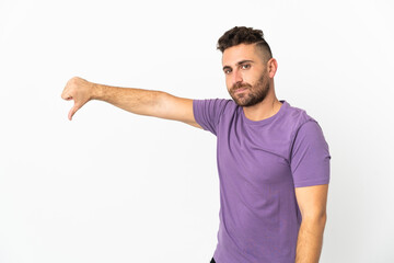 Caucasian man isolated on white background showing thumb down with negative expression