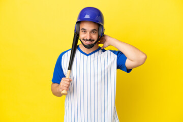 Young caucasian man playing baseball isolated on yellow background laughing