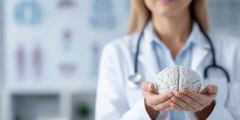 A woman in a white lab coat holding a brain model