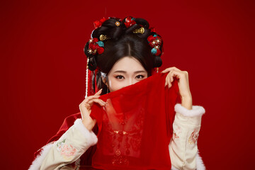 Young woman wearing Chinese Hanfu against a festive red background