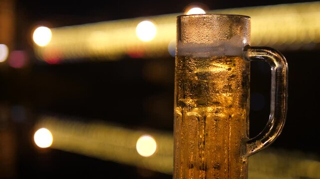 Cold Beer Mug with Bubbles and Foam in Night Light &ndash; Refreshing Alcoholic Drink Concept