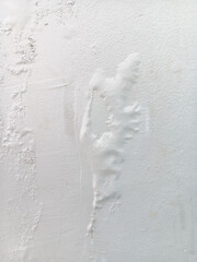 Abstract texture of blistering or bubbles paint on a white wall.