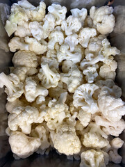 White cauliflower frozen lying in the freezer at the store, vertical picture...