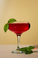 Red alcoholic cocktail on a light background. Alcoholic drink