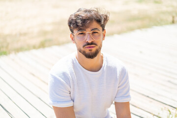 Handsome Arab man at outdoors With glasses
