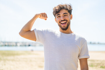 Handsome Arab man at outdoors doing strong gesture