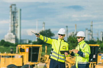 Professional engineer working outdoor, petroleum plant construction team survey site inspection process