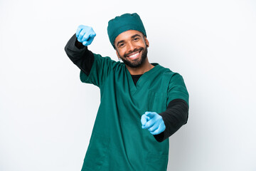 Surgeon Brazilian man in green uniform isolated on white background points finger at you while smiling