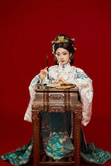 Girl wearing Chinese Ming Dynasty Hanfu costume against a red background