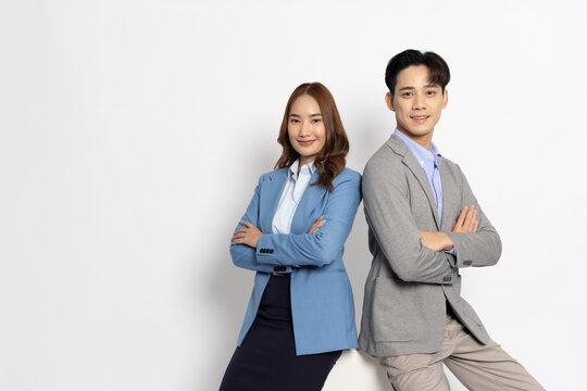 Portrait of successful business asian couple in suit with arms crossed and smile isolated over white background