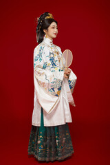 Girl wearing Chinese Ming Dynasty Hanfu costume against a red background