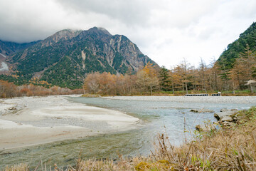 landscape view of japan alps mountain with natural forest, blue river on autumn season at kamikochi Nagano.