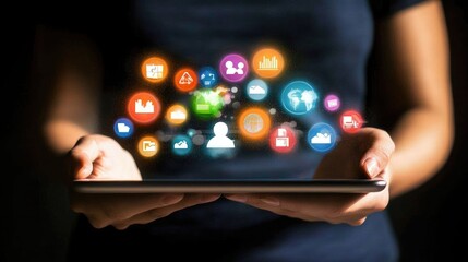 Hands holding a tablet displaying floating application icons.