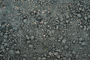 A black and gray background with a few rocks scattered around