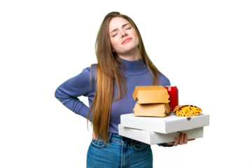 Young pretty woman holding pizzas and burgers over isolated chroma key background suffering from backache for having made an effort