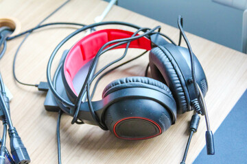 Professional Gaming Headphones with Red Ear Cushions Resting on White Surface