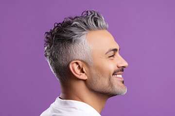 Obraz premium Purple solid background. A relaxed man looking serene in his portrait. Classy men's high fade haircut - midlife middle eastern man with curly hair. Visual idea art of style for aging men.