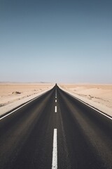 Minimalist desert highway stretching endlessly into the horizon