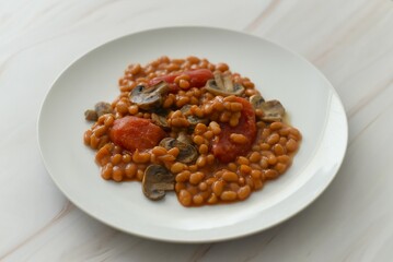 Baked beans with canned tomatoes and fried mushrooms.