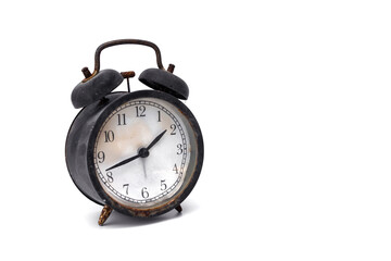 An old abandoned Black alarm clock analog classic vintage style is rusty and dirty isolated on...