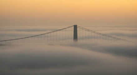 Fototapeta premium Bridge emerging from fog at sunrise