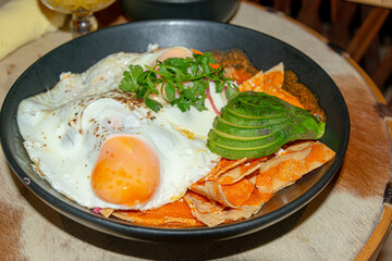 Chilaquiles with Fried Egg – Traditional Mexican Breakfast..