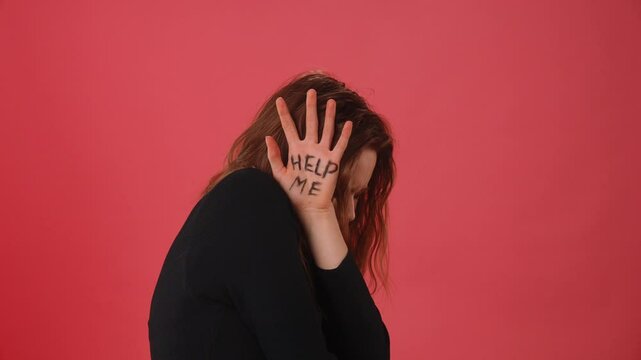 Person with Help Me Written on Hand as Distress Signal