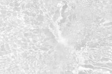 Fototapeta premium White water with ripples on the surface. Defocus blurred transparent white colored clear calm water surface texture with splashes and bubbles. Water waves with shining pattern texture background.