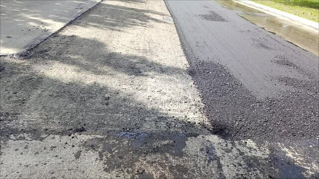 Patches on the asphalt road. Partial repair of the road surface. Construction of roads and highways. 