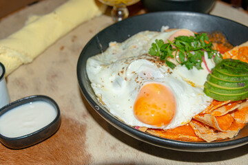 Chilaquiles with Fried Egg – Traditional Mexican Breakfast..