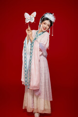 Beautiful woman wearing Chinese Ming Dynasty Hanfu with hairpin and flower ornaments on red background