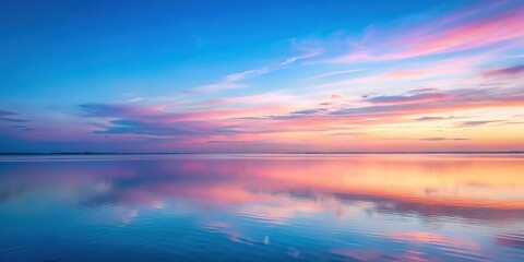 Serene landscape at dusk with soft pastel hues of pink and blue gently fading into the distance amidst a vast expanse of sky , soft focus, blue skies