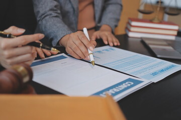 Judge gavel with Justice lawyers having team meeting at law firm background. Concepts of Law and Legal services.