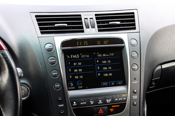 Radio in old lux sedan. Car radio. Old car multimedia system screen. Dashboard in a modern classic car. Control Panel of a old business car. 
