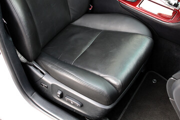 Obraz premium Driver seat of a lux car. Leather car interior. Black leather drivers seat in a car. Front seats of a modern business class sedan car. 