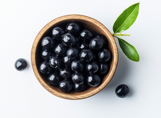 Dark Tapioca Pearls in Wooden Bowl with Green Leaves
