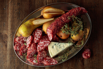 Dry-cured sausages, blue cheese, thyme and pears.