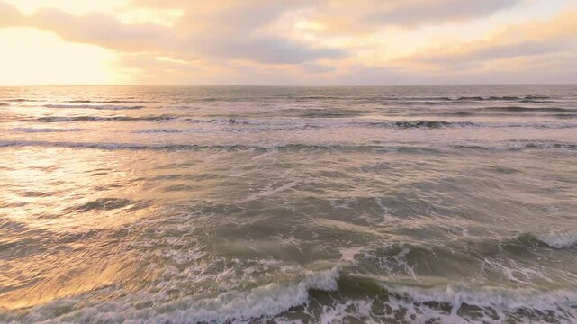 Low Aerial Flyover of Ocean Waves During Sunset | FlyLens 4K