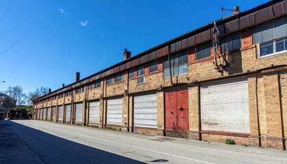 Obraz premium Antique Industrial Storage Building Under Harsh Midday Sunlight